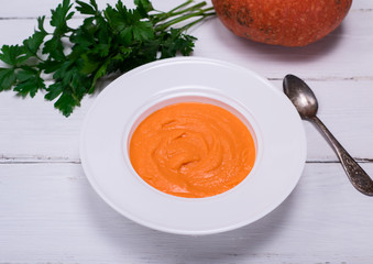 round plate with pumpkin soup