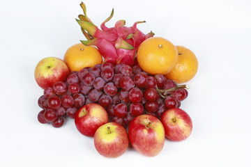 Naklejka na ściany i meble Mixed fruits as Red seedless grapes,orange,apple,Dragon fruit,Japanese golden melon.