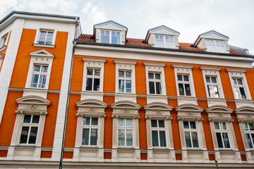 Fototapeta na wymiar red facaded brick building with white stucco