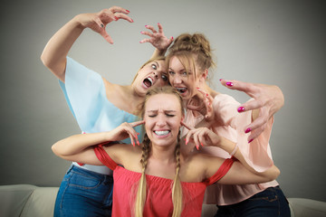 Woman being bullied by two females