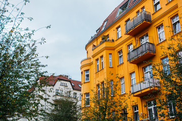 Fototapeta premium orange and white buildings in a row on cloudy day