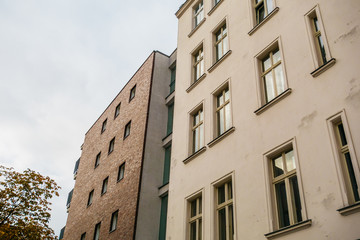 modern brick next to an older white house