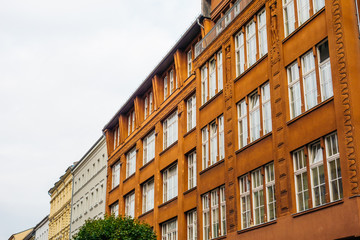 Fototapeta na wymiar brick and apartment buildings in a row at berlin on a cloudy day
