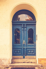 Fototapeta na wymiar blue door on yellow building