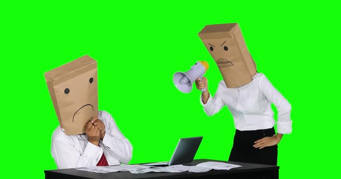 
Angry unidentified businesswoman with a paper bag on her head, scolding her worker with a megaphone while working with laptop on desk. Shot in 4k resolution