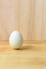 Fresh egg on a Brown wooden background.