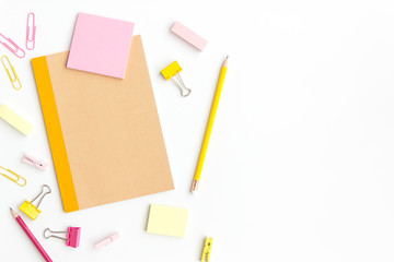 notebook paper, sticky note with pencil, paper clip on white background