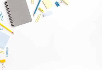 notebook paper, sticky note with pen, paper clip on white background