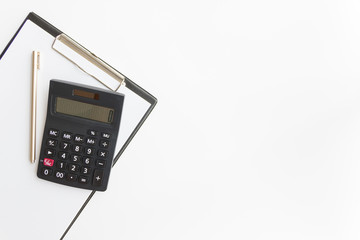 paper plate, pen and black calculator on white background wit copy space