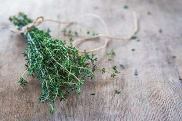 Thyme bunch. Bundle of fresh thymes on a wooden background