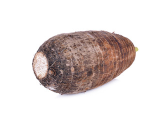 unpeeled raw taro on white background