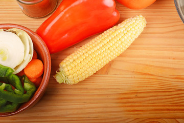 Vegetables and seasonings on wooden table.