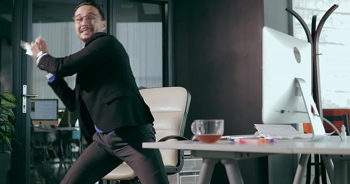 businessman in the office in front of the computer, showing anger. showing anger