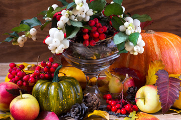 Fall background with snowberry and rowan arrangement