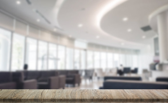 Wooden Table In Hotel Lobby With Big Windows