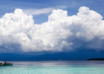 Tropical ship sailing with beautiful cloudscape and seascape.