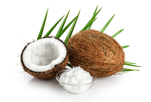 Coconut and bowl with coconut oil isolated on white background.