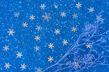 Lilac branch on a blue background with snowflakes