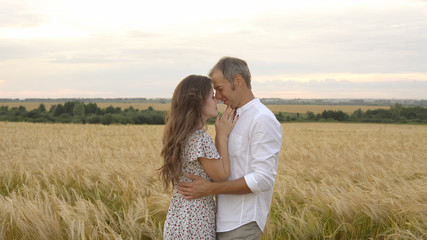 Romantic date on a wheat field, love couple hugs
