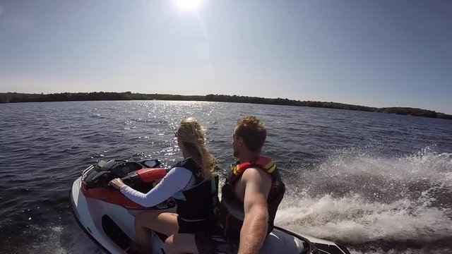 seadoo girl driving over rough waves with guy filming