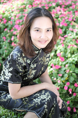 Naklejka premium Portrait of middle aged of Chinese business women in Chinese black outfit at the park in summer .