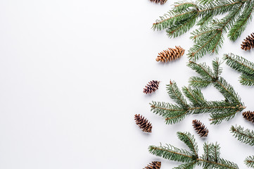 Fototapeta na wymiar Spruce branches and cones on white background. Christmas pattern