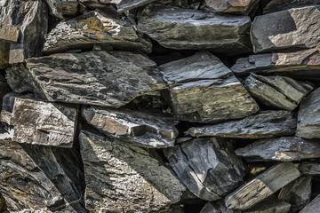 The stones are stacked on top of each other and form a wall.