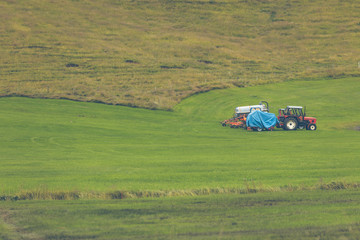 Fototapeta premium Tractor with plowes on an Iceland field