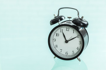 Retro alarm clock on a glass table
