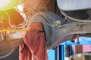 A man maintenance truck differential, fill differential oil.
