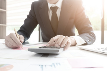 Finance concept,finance control audit man calculate business financial data on calculator.