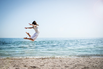 Happy beautiful young girl jumping