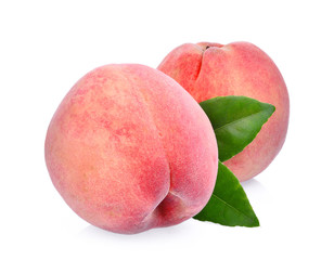 two whole of peach with green leaves isolated on the white background