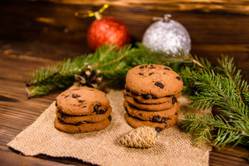 Chocolate chip cookies and christmas decorations on a wooden table