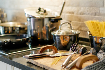 Kitchen utensils on wooden table knives spaghetti pasta