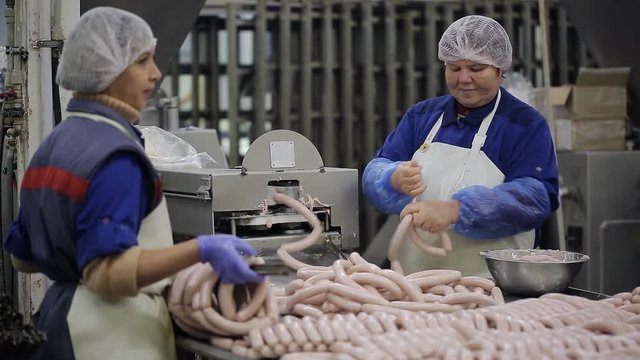 Sausages production at the meat processing factory.