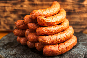 Stack of deliciously smoked handmade Swedish Isterband sausages with natural casing.