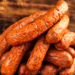 Large pile of deliciously smoked handmade Swedish Isterband sausages with natural casing.