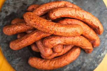 Large pile of deliciously smoked handmade Swedish Isterband sausages with natural casing.