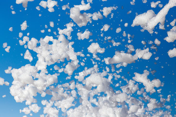 White foam against the blue sky as background