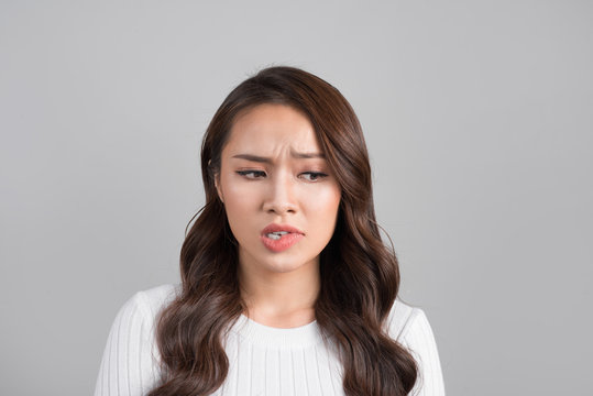 A Portrait Of Young Asian Woman With Annoyed Face