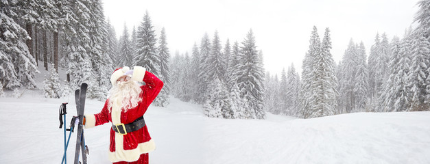 Santa Claus skier on the background of the ski landscape. Vacation in winter in the mountains for...