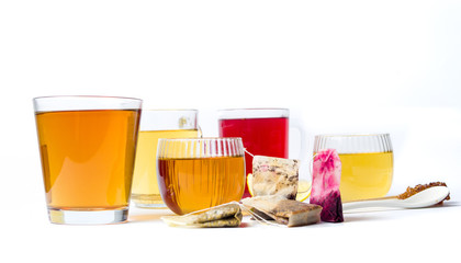 Various herbal tea in glass cups on white
