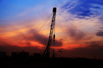 the silhouette of oilfield derrick