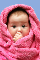 portrait of a baby infant in towel