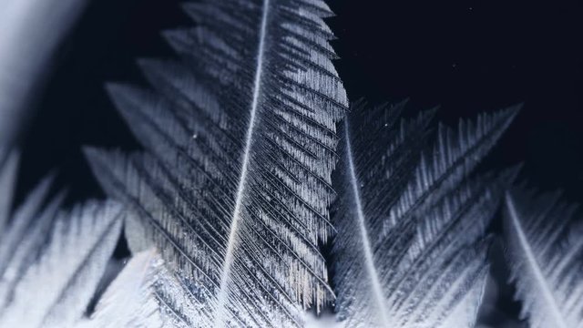 Freezing window close-up, winter holidays background,