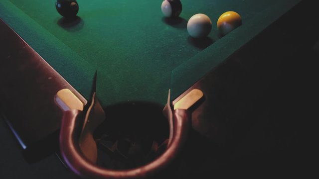 American billiard. Man playing billiard, snooker. Player preparing to shoot, hitting the cue ball.