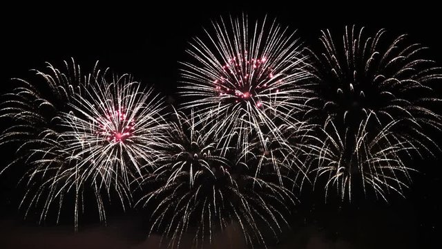 4K video footage of colorful bright pyrotechnic show, flashes of salute firework of different colors close up view