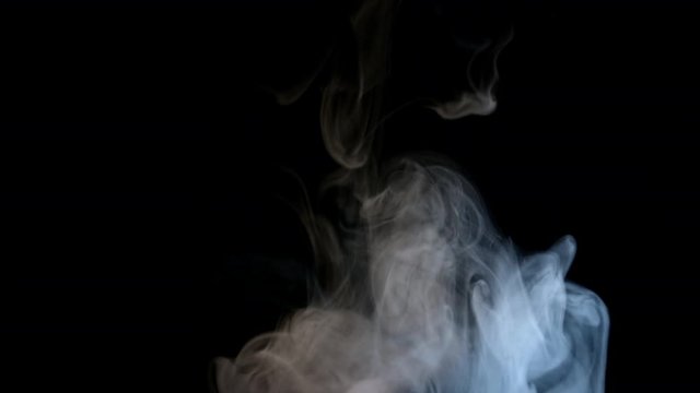 Smoky fog clouds over a black background. You can add this footage to your video project by dropping it in and changing its blending mode to Screen or Add
