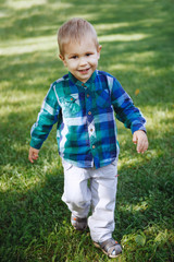 Little boy having fun playing in the Park on the grass